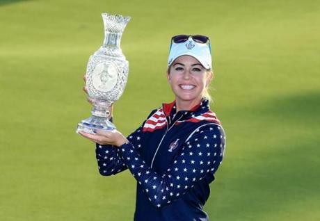 Paula Creamer proudly held the Solheim Cup trophy after the US staged a historic comeback to claim the title