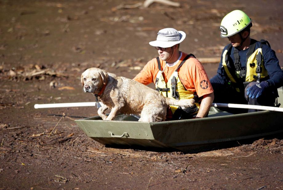 Searchers continue to comb through mud and debris for the remaining victims of a flash flood Thursday Sept. 17 2015 in Hildale Utah. The flood water swept away multiple vehicles in the Utah Arizona border town killing several people