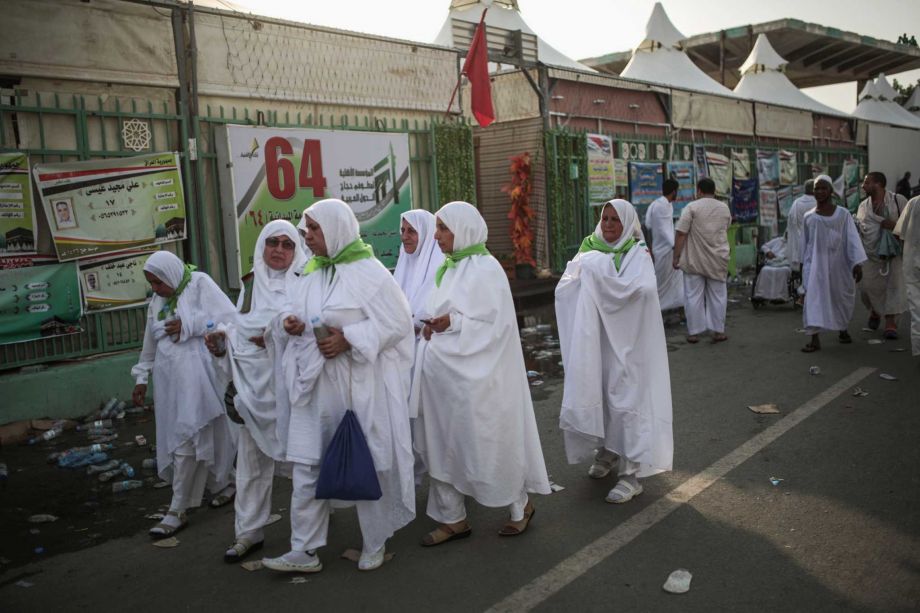 Muslim pilgrims walk by the site where pilgrims were crushed and trampled to death during the annual hajj pilgrimage in Mina Saudi Arabia Thursday Sept. 24 2015. The crush killed hundreds of pilgrims and injured hundreds more in Mina a large valley