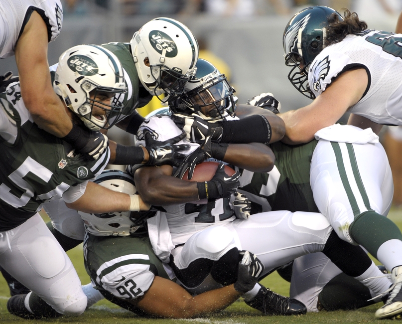 Aug 28 2014 Philadelphia PA USA Philadelphia Eagles running back Kenjon Barner is tackled by New York Jets linebacker Nick Bellore, defensive back Rontez Miles, defensive tackle Tevita Finau and defensive tackle T.J. Barnes