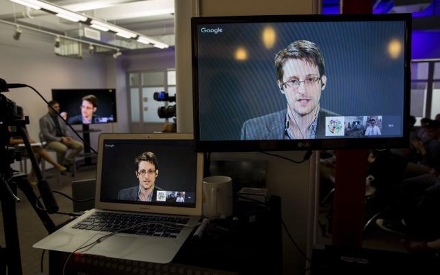 American whistleblower Edward Snowden is seen on monitors as he delivers remarks via video link from Moscow to attendees at a discussion regarding an International Treaty on the Right to Privacy Protection Against Improper Surveillance and Protection