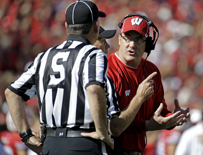 Wisconsin head coach Paul Chryst right argues a call during the first half of an NCAA college football game against Troy Saturday Sept. 19 2015 in Madison Wis