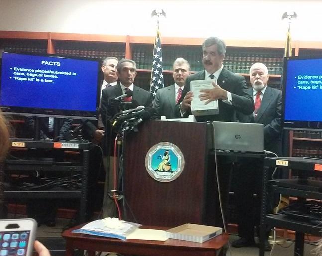 Erie County District Attorney Frank Sedita holds up a rape kit evidence box during a Friday morning news conference