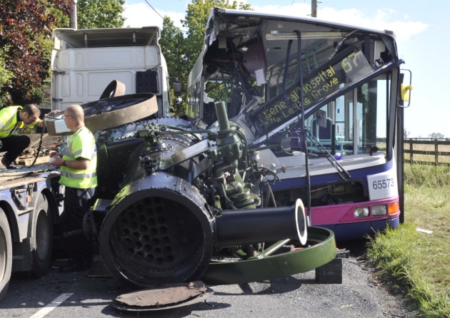 Essex Police investigate a collision on East Mersea Road between a bus and a low-loader lorry which was carrying a steam engine