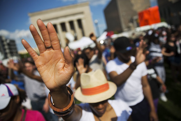 People pray during a rally at Baltimore City Hall on May 3. Hundreds of jubilant people prayed and chanted for justice days after the city's top prosecutor charged six officers involved in Freddie Gray's arrest