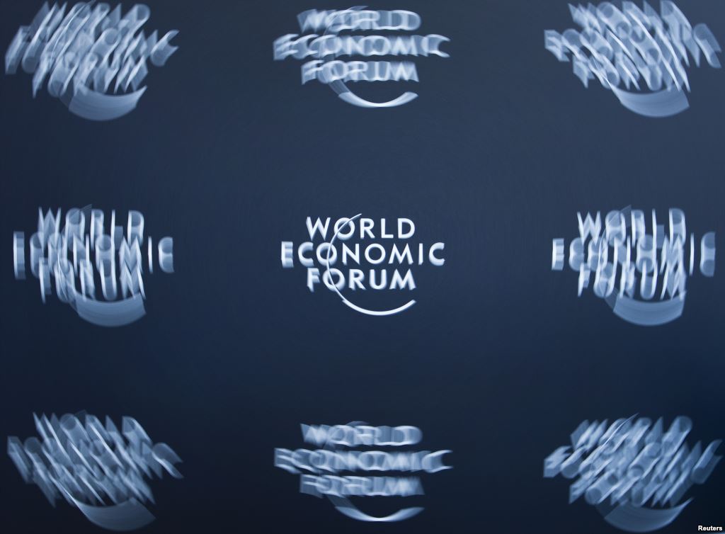 FILE- A logo taken with long exposure is shown at the World Economic Forum headquarters in Cologny near Geneva