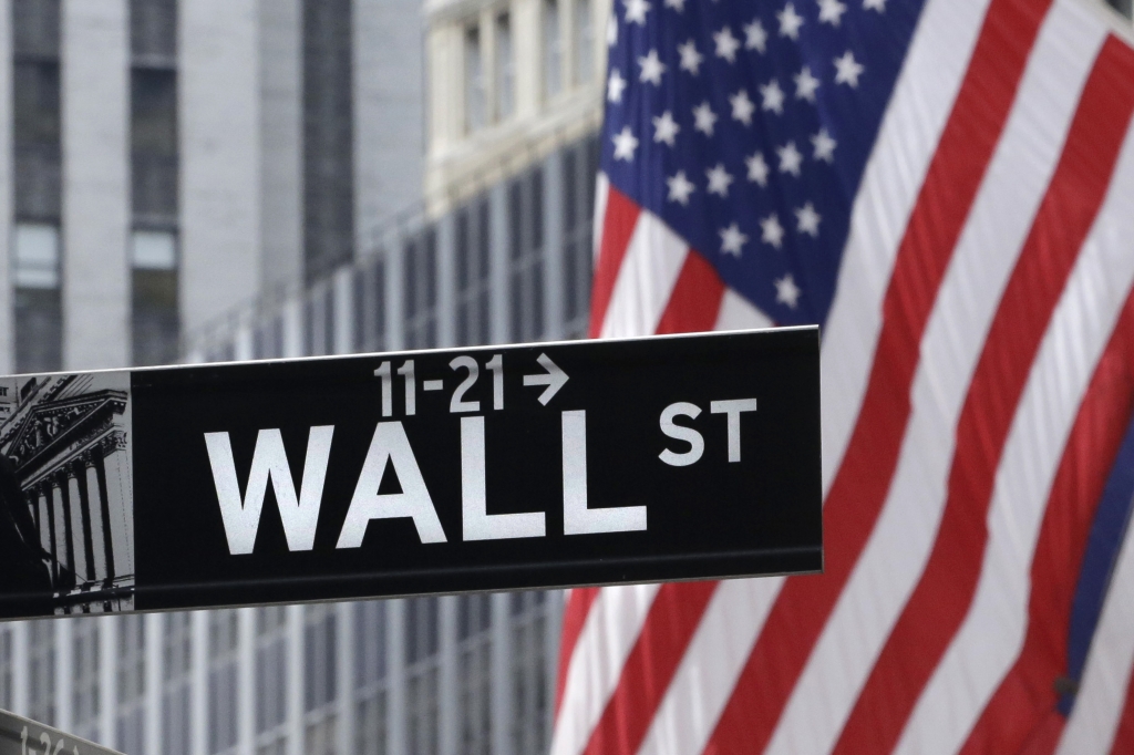 American flags fly at the New York Stock Exchange on Wall Street. Global stock markets were uneven Monday Sept. 21 2015 after the Fed's decision to delay a rate hike added to pessimism about global growth prospe