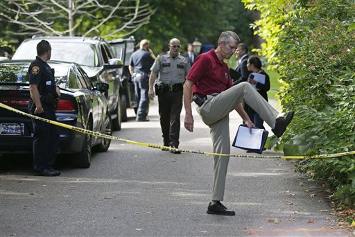 South Lake Minnetonka interim Police Chief Michael Siitari right climbs over the police tape to address the media Thursday Sept. 10 2015 in Greenwood Minn. after five family members including three children were found dead in their lakeside home