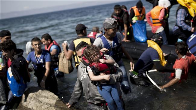 Syrian refugees arrive on the shores of the Greek island of Lesbos after crossing the Aegean Sea from Turkey on an inflatable dinghy