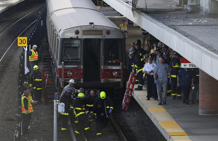 Dorchester Massachusetts- 9/21/2015- Firefighters carry the remains of a man who was struck and killed by a red line train at the JFK  UMASS MBTA station in Dorchester Massachusetts