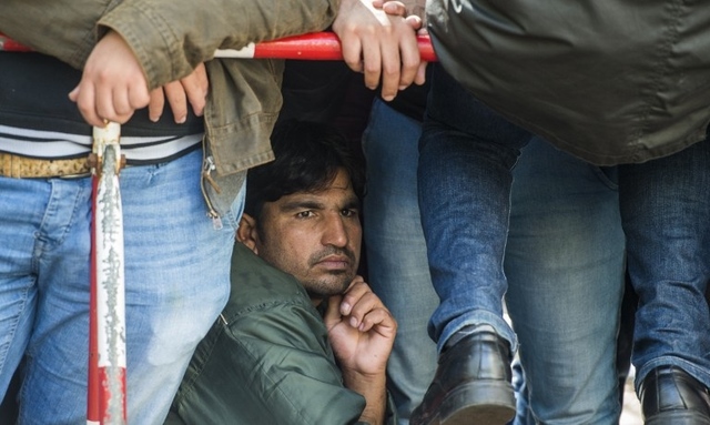 WAITING. Asylum-seekers wait to register outside the State Office of Health and Social Affairs in Berlin where hundreds of migrants wait to receive help from the Berlin administration