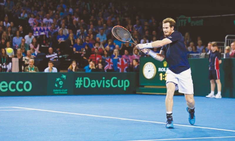 GLASGOW Great Britain’s Andy Murray hits a return to Bernard Tomic of Australia during their reverse singles match in the Davis Cup semi-final at the Emirates Arena on Sunday.—Reuters