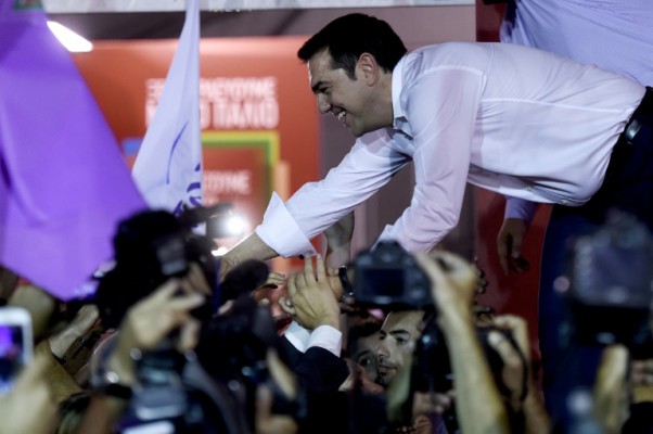 AFP  Aris Messinis Leader of the Greek radical-left Syriza party Alexis Tsipras shakes hands with supporters at the main party's election headquarters in central Athens