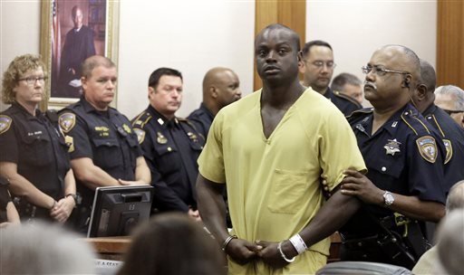 Shannon Miles is escorted out of a courtroom after a hearing Monday Aug. 31 2015 in Houston. Miles has been charged with capital murder in the death of Harris County Sheriff's Deputy Darren Goforth. He is being held without bond. (AP