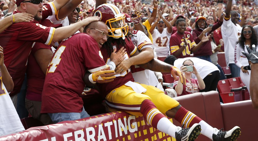 Washington Redskins running back Matt Jones jumps into the fans after scoring a touchdown during the first half of an NFL football game against the St. Louis Rams in Landover Md. Sunday Sept. 20 2015