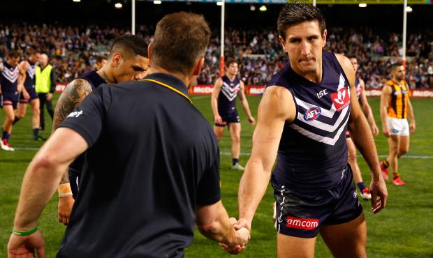 Hawk coach Alastair Clarkson offers Pavlich a handshake after Friday night's match