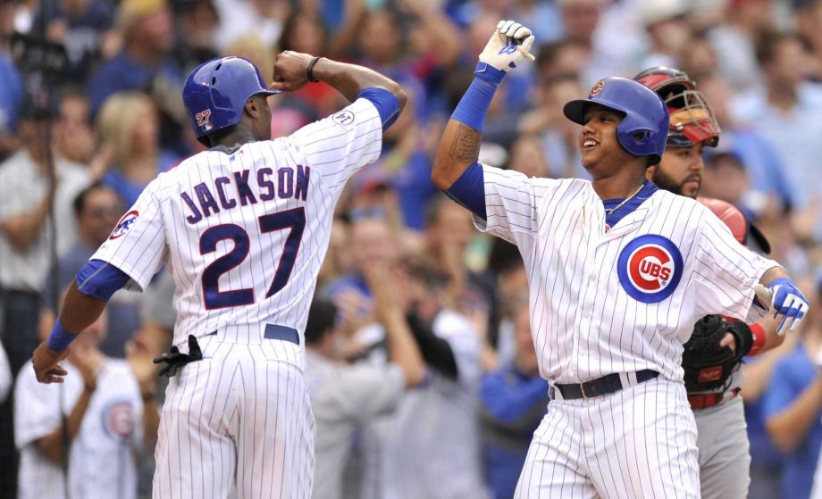 Chicago Cubs Starlin Castro right celebrates with teammate Austin Jackson at home plate after hitting a three-run home run during the sixth inning of a baseball game against the St. Louis Cardinals Friday Sept. 18 2015 in Chicago