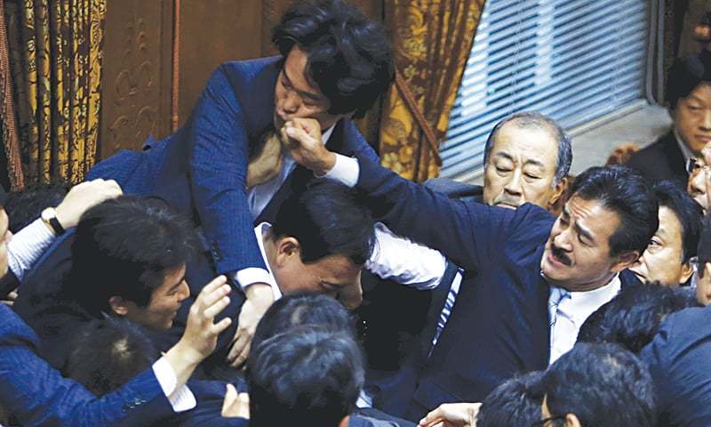 TOKYO Ruling and opposition lawmakers come to blows during a meeting of a committee of the upper house of the National Diet here on Thursday.—Reuters