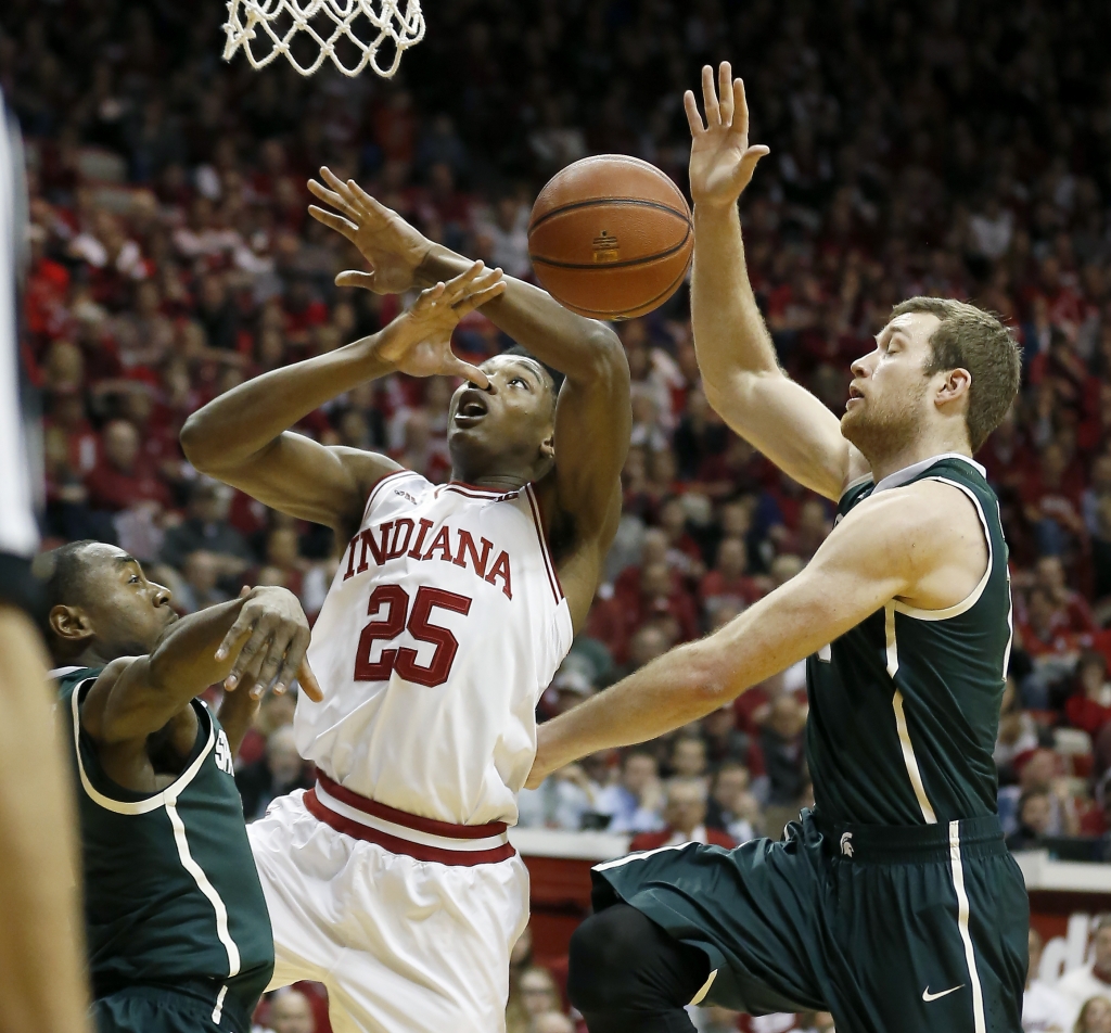 Michigan State guard Lourawls Nairn Jr. left and forward Matt Costello right foul Indiana forward Emmitt Holt during the first half of an NCAA college basketball game in Bloomington Ind. Saturday