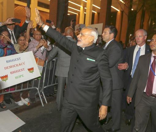 Prime Minister Narendra Modi waves to supporters after arriving at his hotel ahead of the 2015 General Assembly of the United Nations in New York on Thursday