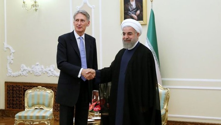 Iran's President Hassan Rouhani right welcomes British Foreign Secretary Philip Hammond at the start of their meeting in his office in Tehran Iran Monday Aug. 24 2015