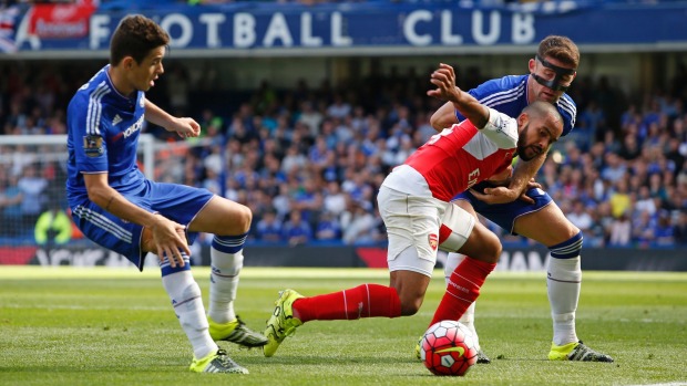 Chelsea's Oscar left and Gary Cahill right keep a close eye on Arsenal's Theo Walcott at Stamford Bridge