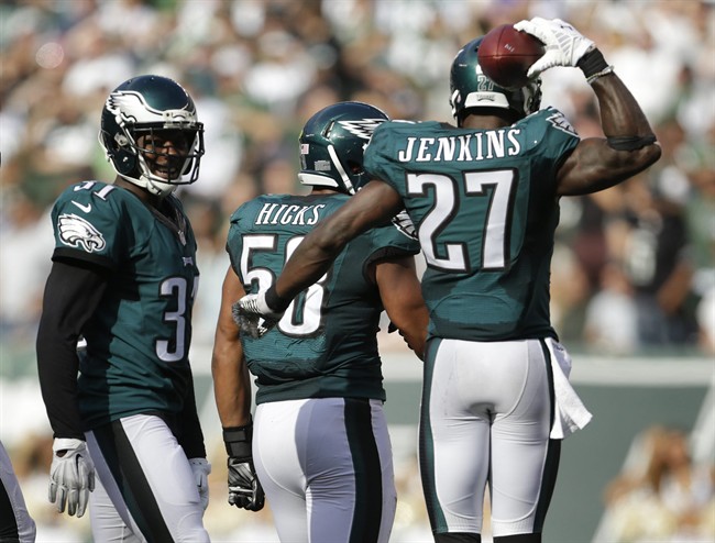 Philadelphia Eagles cornerback Byron Maxwell and free safety Malcolm Jenkins celebrate with Philadelphia Eagles outside linebacker Jordan Hicks after Hicks intercepted a pass by the New York Jets during the fourth quarter of an NFL football