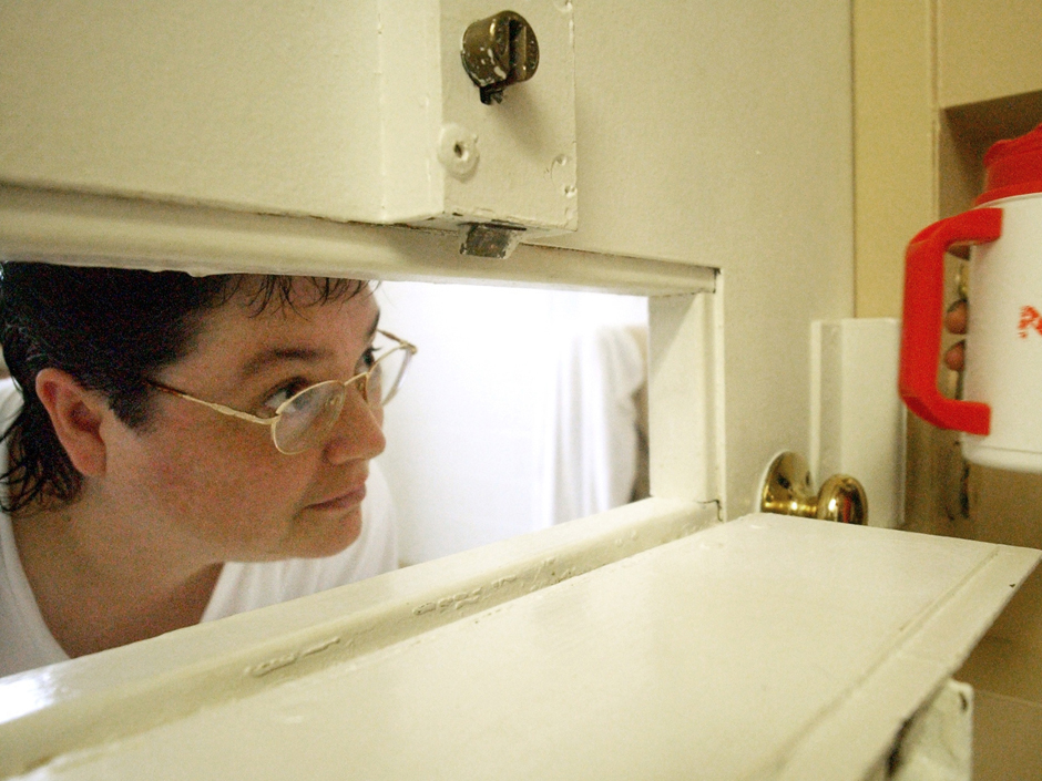 Kelly Renee Gissendaner the only woman on Georgia's death row looks through the slot in her cell door as a guard brings her a cup of ice at Metro State Prison in Atlanta