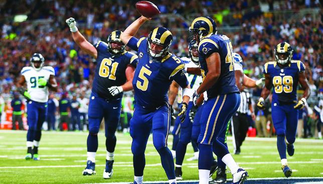 Sharp spike Rams Nick Foles celebrates his third-quarter touchdown