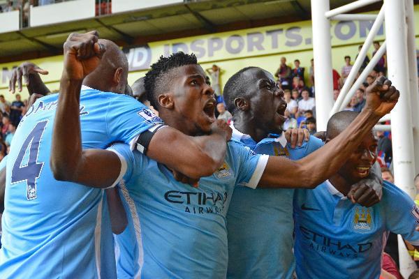 Kelechi Iheanacho celebrates with team mates after scoring the first goal for Manchester City