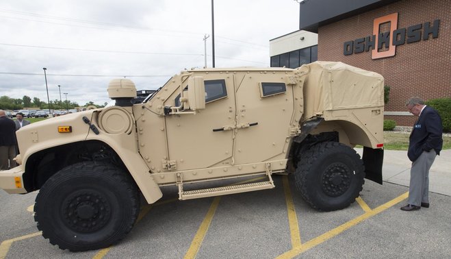 Oshkosh Mayor Steve Cummings examines a Joint Light Tactical Vehicle after a ceremony unveiling the vehicle Aug. 26 at Oshkosh Corp. in Oshkosh