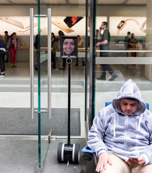 Lucy the robot is queuing up outside to get an iPhone 6s- whilst her owner stays nice and warm