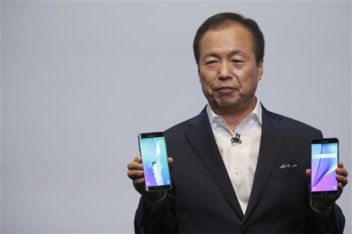 JK Shin president and CEO of Samsung Electronics holds the Samsung Galaxy S6 Edge Plus left and the Samsung Galaxy Note 5 during a presentation Thursday Aug. 13 2015 at Lincoln Center in New York