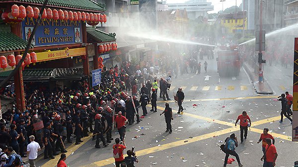 Riot police fire a water cannon to pro-government'red shirt protesters as they try to enter China Town during a demonstration in Kuala Lumpur Malaysia Wednesday. Pic AP