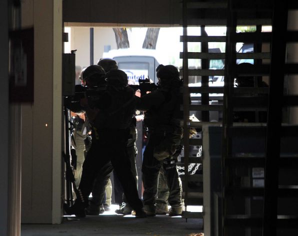 Sparks and Reno police officers work during a raid at Courtside Garden Apartments in Sparks Nev. The investigation into the deaths of a ghost-hunting couple Debra and Mark Constantino has determined a male roo