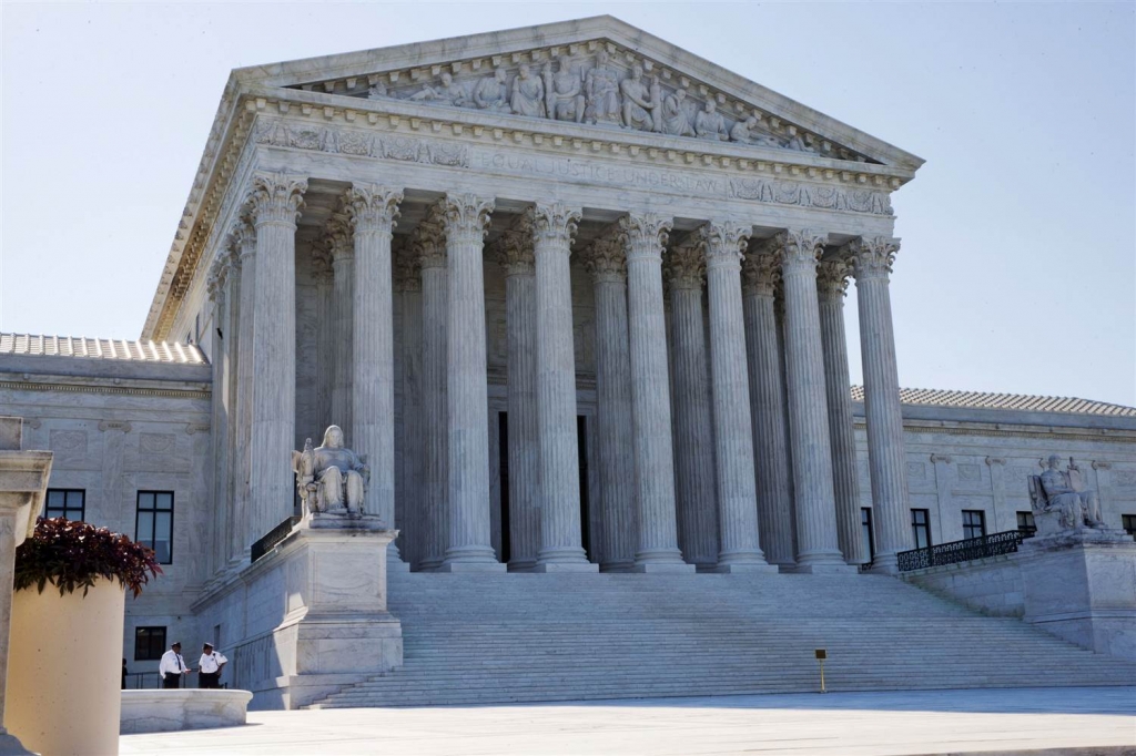 Members of security stand outside of the Supreme Court in Washington Monday