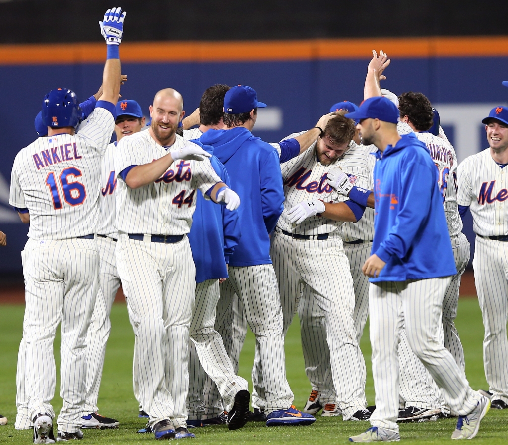 NEW YORK NY- MAY 28 Teammates swarm Lucas Duda #21 of the New York Mets after Duda drove in the game winning run against the New York Yankees