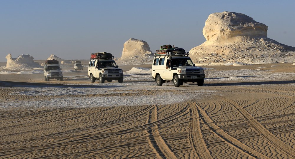 Four-wheel drive cars cross the sand dunes in the Egyptian western desert and the Bahariya Oasis southwest of Cairo