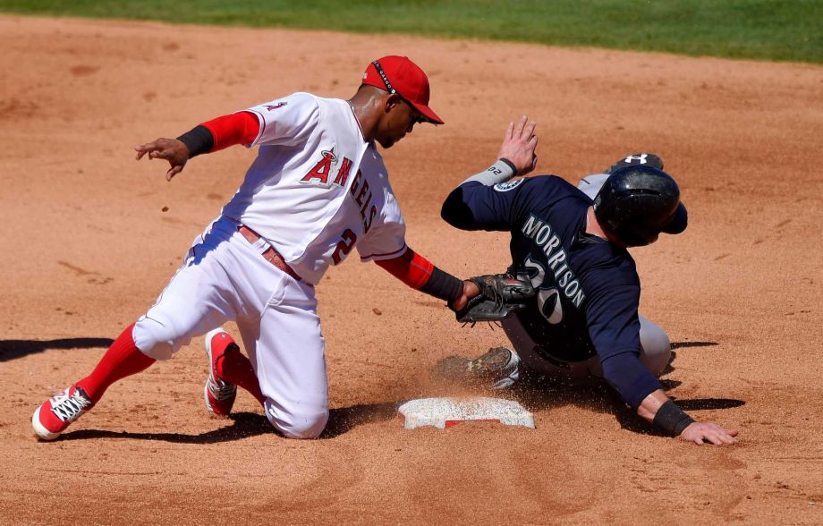 Seattle Mariners Logan Morrison right is tagged out by Los Angeles Angels shortstop Erick Aybar while trying to steal second during the fifth inning of a baseball game Sunday Sept. 27 2015 in Anaheim Calif. Morrison was originally called safe on