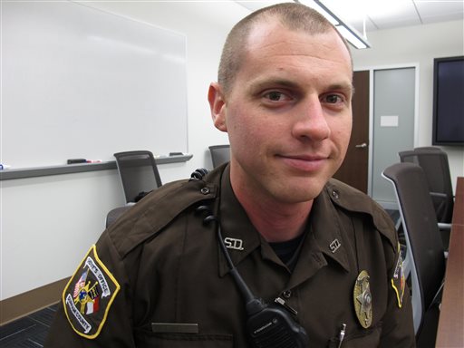 Durham County Sheriff's Deputy David Earp speaks to reporters at headquarters in Durham N.C. on Tuesday Sept. 22 2015. Earp pulled two young girls out of a pond Sunday night after their father allegedly tried to drown them and their brother. (AP P