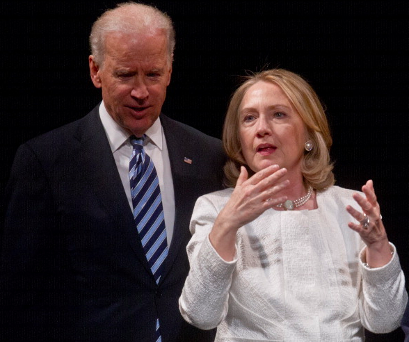 Former US Secretary of State Hillary Clinton and Vice President Joe Biden speak at the end of the Vital Voices Global Awards ceremony at the Kennedy Center in Washington