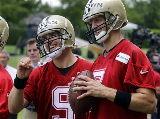 New Orleans Saints quarterbacks Drew Brees and Luke Mc Cown challenge each other to a skills passing game after an NFL football organized team activity in Metairie La. Brees will be sidelined for New Orlean