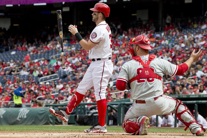 Washington Nationals Bryce Harper flips his bat in the air while batting in the first inning of a baseball game against the Philadelphia Phillies at Nationals Park in Washington on Sunday Sept. 27 2015 next to Phillies catcher Erik Kratz