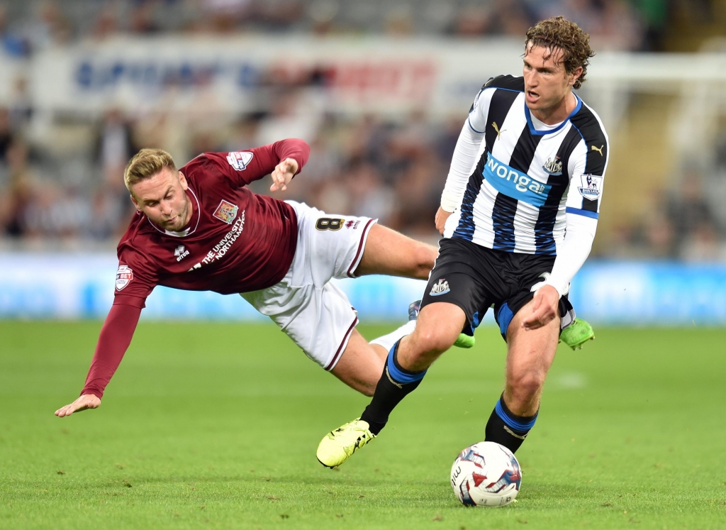 Newcastle's Daryl Janmaat with Northampton's Joel Byrom battle for the ball during the Capital One Cup second round match at St James Park last month