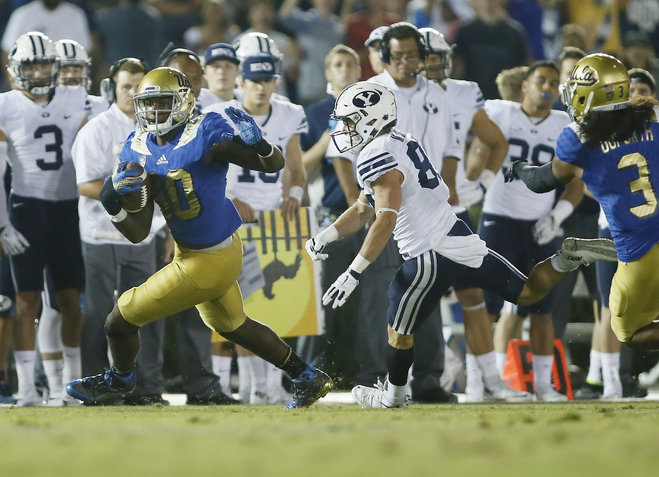 UCLA linebacker Myles Jack runs with the ball after intercepting the ball while BYU wide receiver Mitchell Juergens runs after him late in the fourth quarter of an NCAA college football game Saturday Sept. 19 2015 in Pasadena Calif. UCLA won 24-23