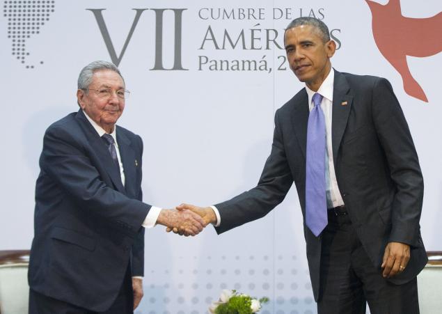 Cuba President Raul Castro left and President Obama gripped and grinned for the cameras at the top of their meeting Tuesday with Castro jokingly gesturing about Obama's height