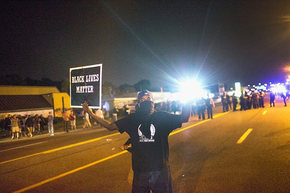 FERGUSON MO- AUGUST 10 A demonstrator marking the one-year anniversary of the shooting of Michael Brown confronts police during a protest along West Florrisant Street