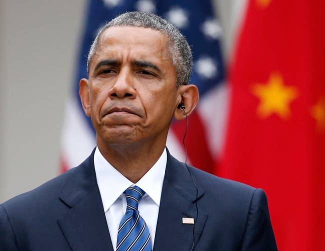 President Barack Obama listens to Chinese President Xi Jinping's opening remarks during their joint news conference in the Rose Garden of the White House