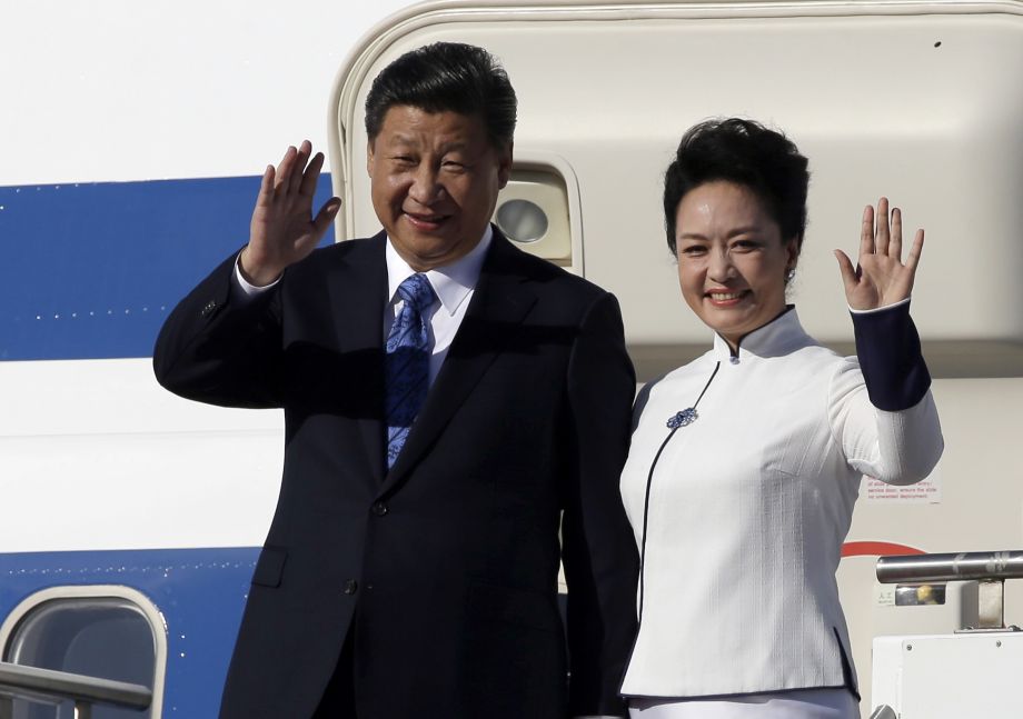 Chinese President Xi Jinping left and his wife Peng Liyuan wave upon arrival Tuesday Sept. 22 2015 at Boeing Field in Everett Wash. Xi is spending three days in Seattle before traveling to Washington D.C. for a White House state dinner on Friday