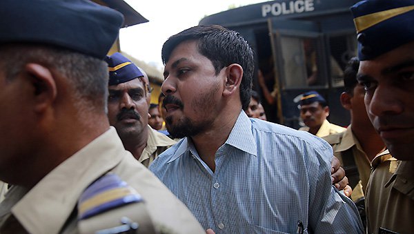 One of the men accused in the 2006 Mumbai train bombings is escorted by policemen from a prison to a court in Mumbai India Wednesday. Pic AP